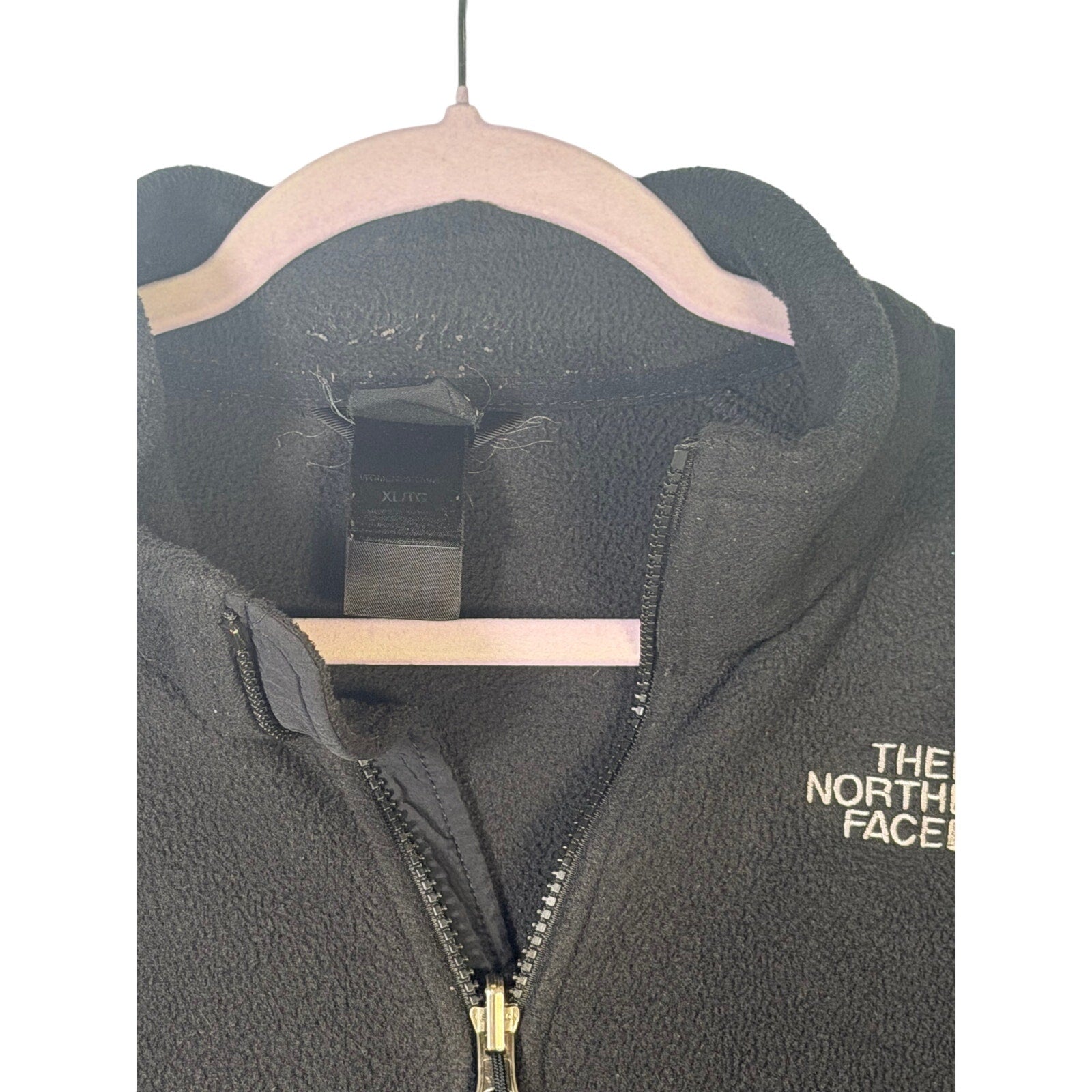 The North Face women's black full-zip fleece jacket with outdoor logo, size XL, lightweight and cozy for outdoor activities.