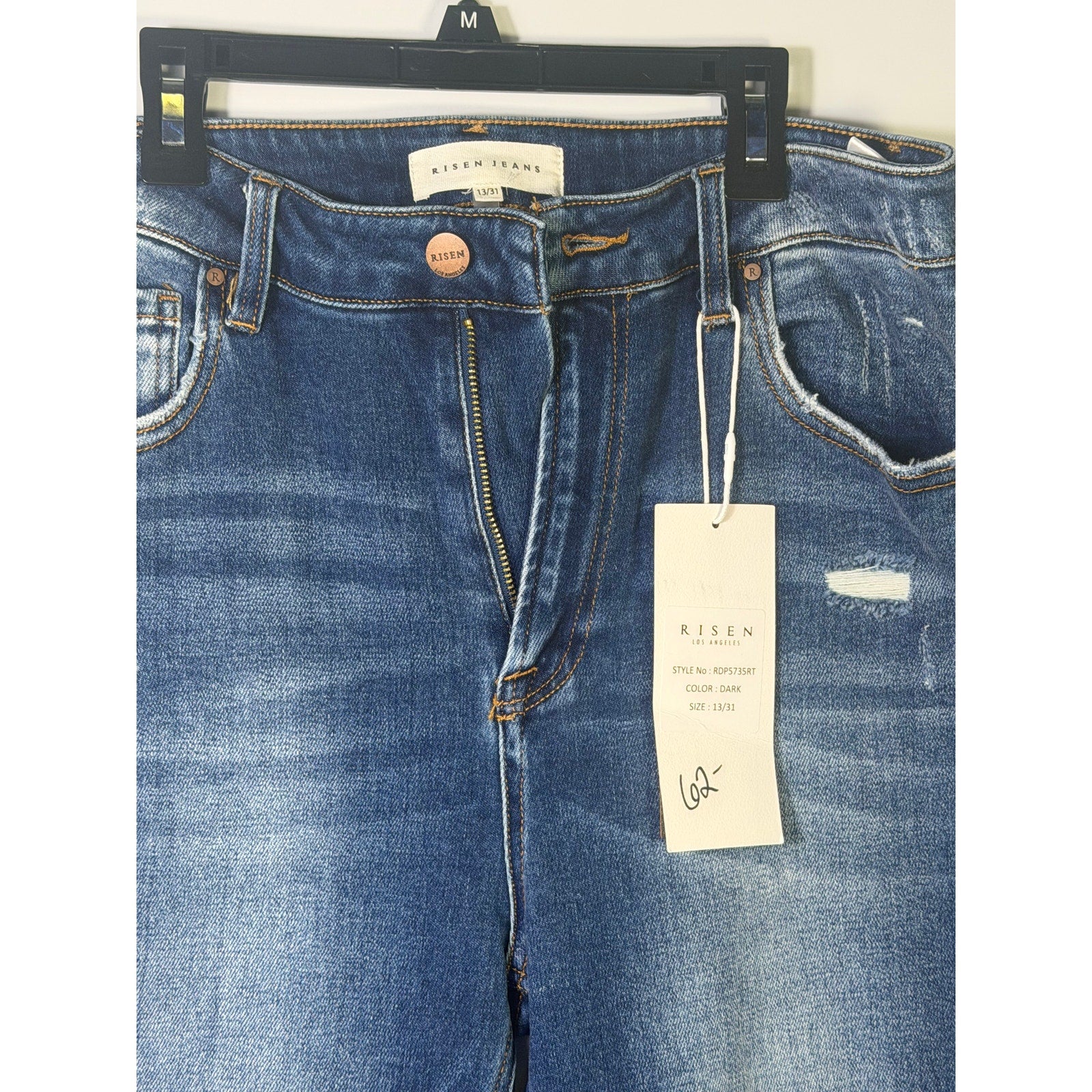 Risen Jeans women's size 13 dark wash distressed flare jeans with frayed hems and classic five-pocket design.