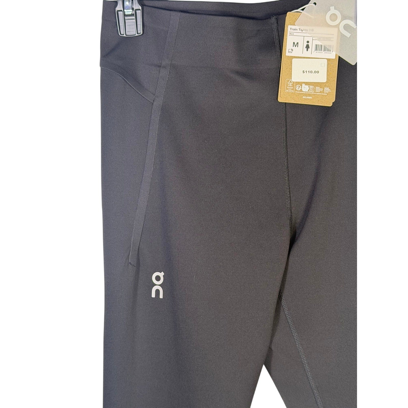 Black On Women’s Train Tights 7/8 leggings, size M, showing close-up of fabric and fit on model.