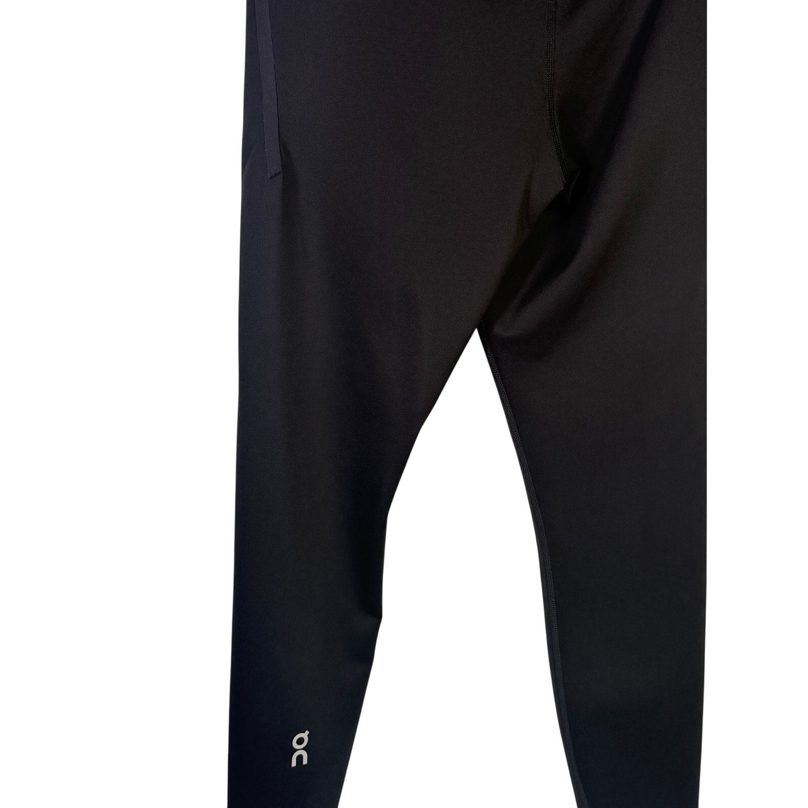On Women’s Train Tights 7/8 leggings in black, size M, showing the stretchy, fitted fabric and athletic design.