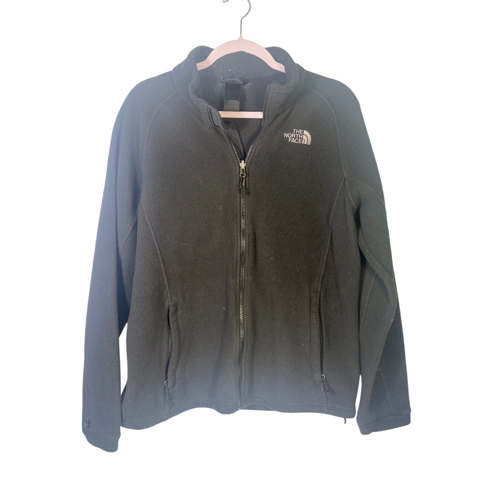 The North Face women's black full-zip fleece jacket with outdoor logo, showcasing a cozy, full-zip design and logo details.