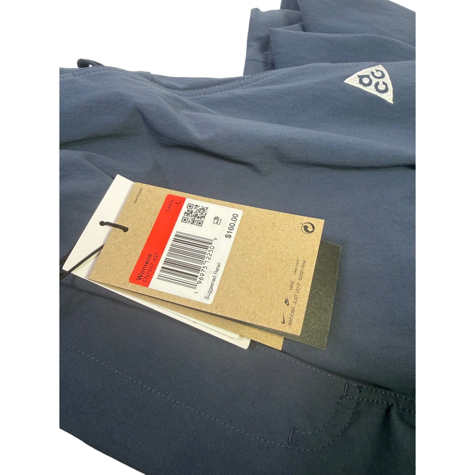 Nike ACG Smith Summit women's cargo pants in thunder blue, size L, with multiple pockets and rugged outdoor style.