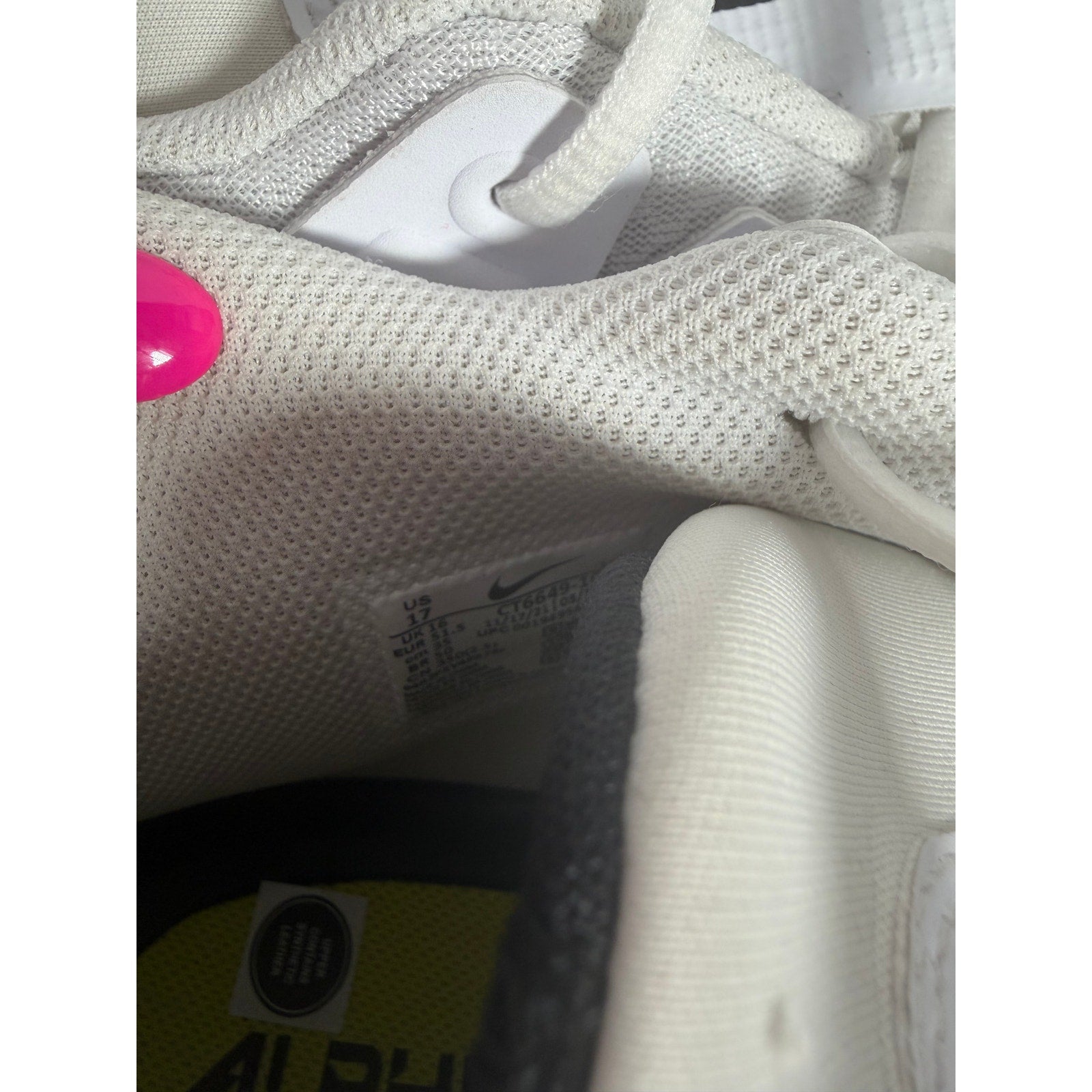 Nike Alpha men's football cleats in white and black, size 17, with cleat studs and Nike logo visible.