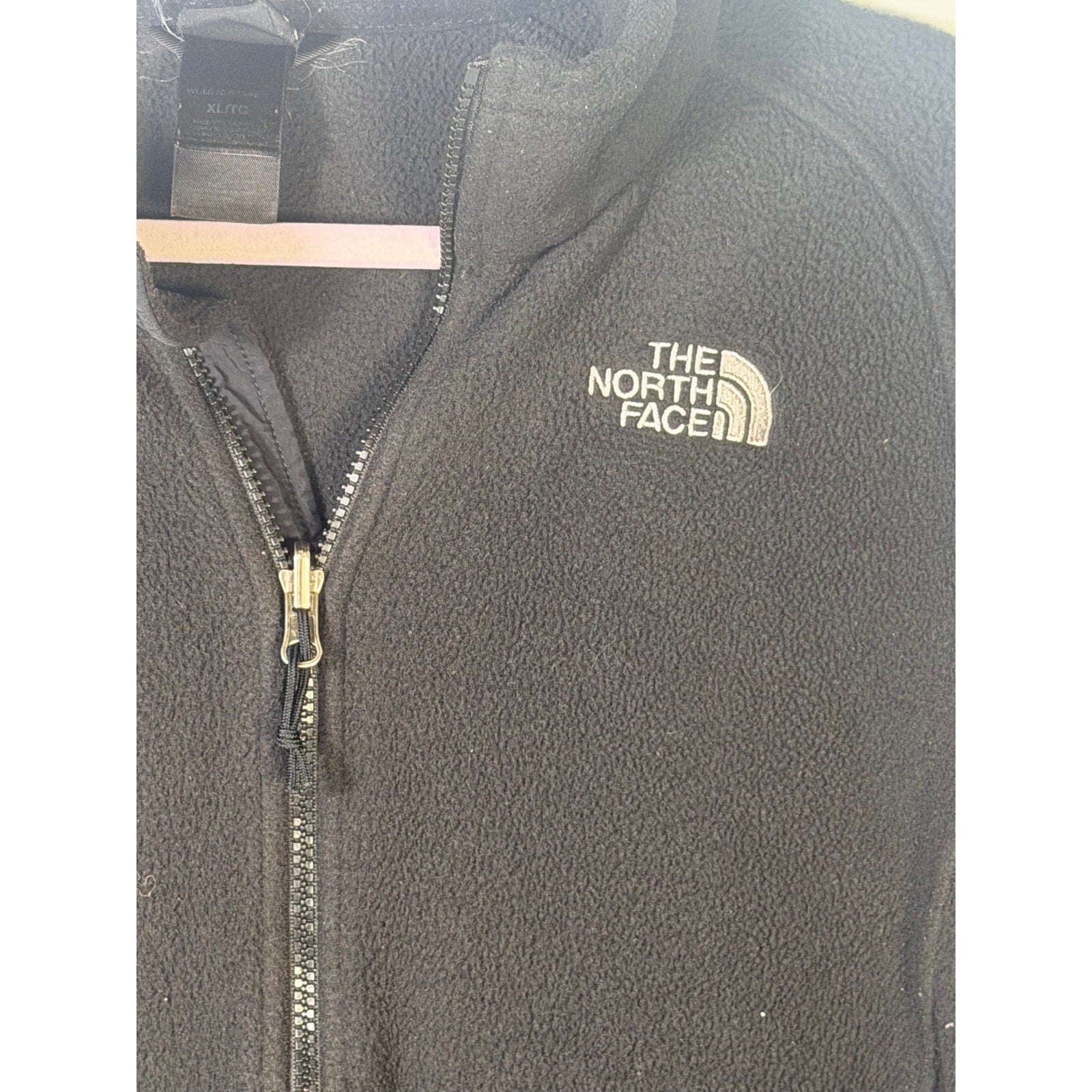 The North Face women's black full-zip fleece jacket with outdoor logo, XL size, soft and warm outdoor apparel.
