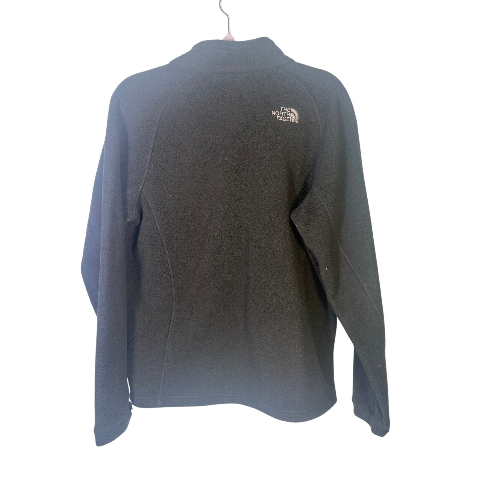 The North Face women's black full-zip fleece jacket with outdoor logo, featuring a cozy fit and full-length zipper.