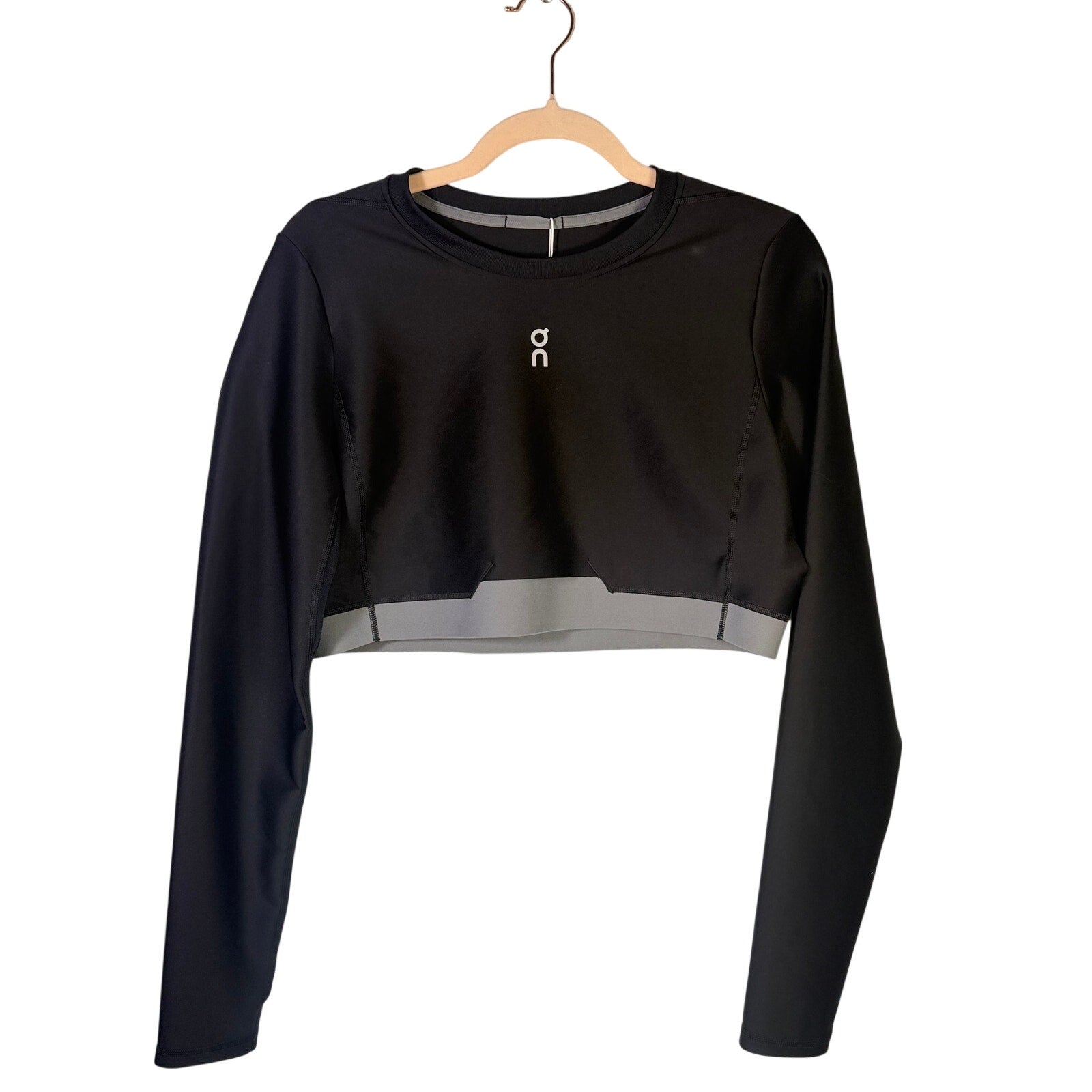 On Women's Train Long-Sleeve Crop Athletic Top in black, size XL, made for active wear and fitness activities.