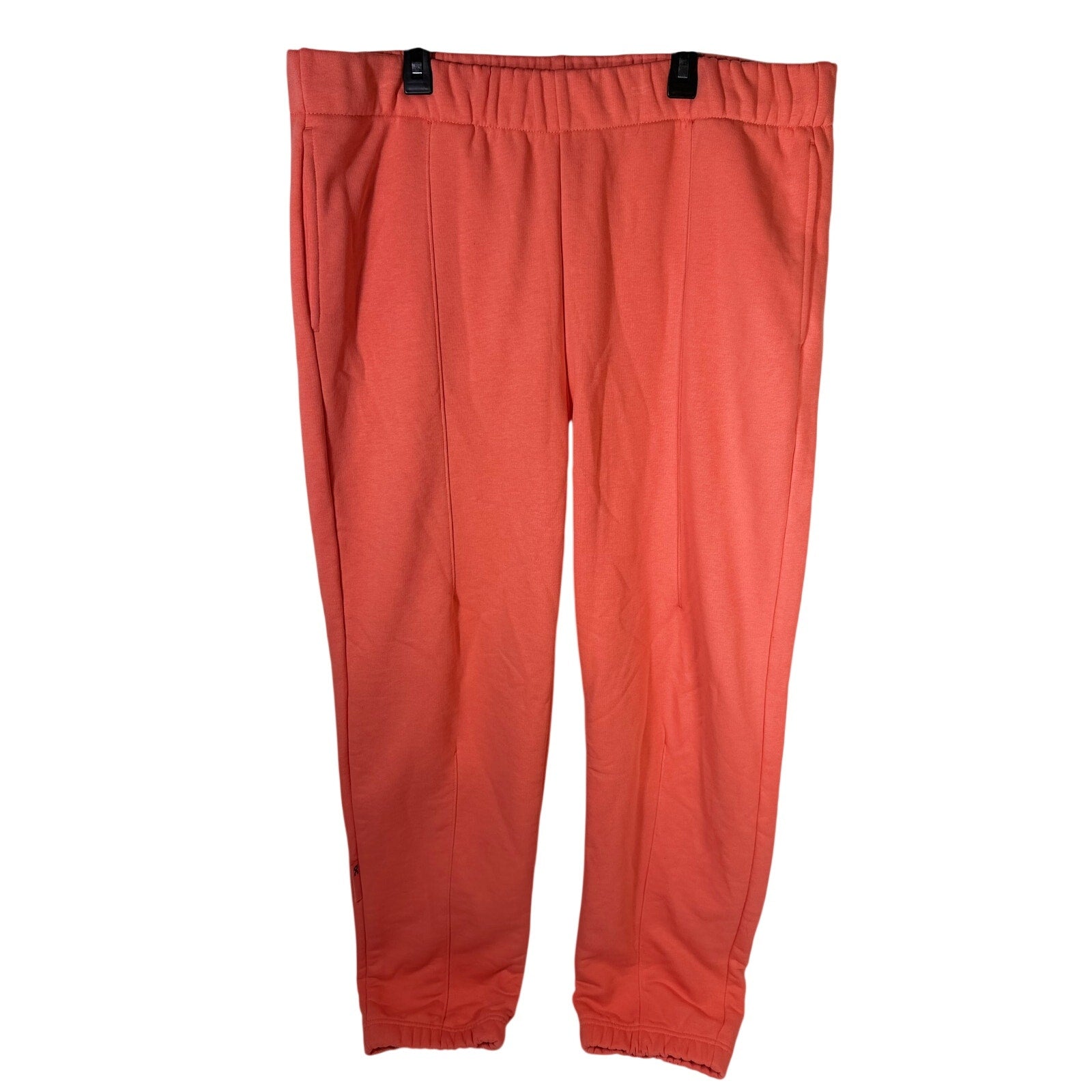 On Running women's coral orange ribbed jogger sweatpants in size XL, showing the relaxed fit and comfortable fabric.