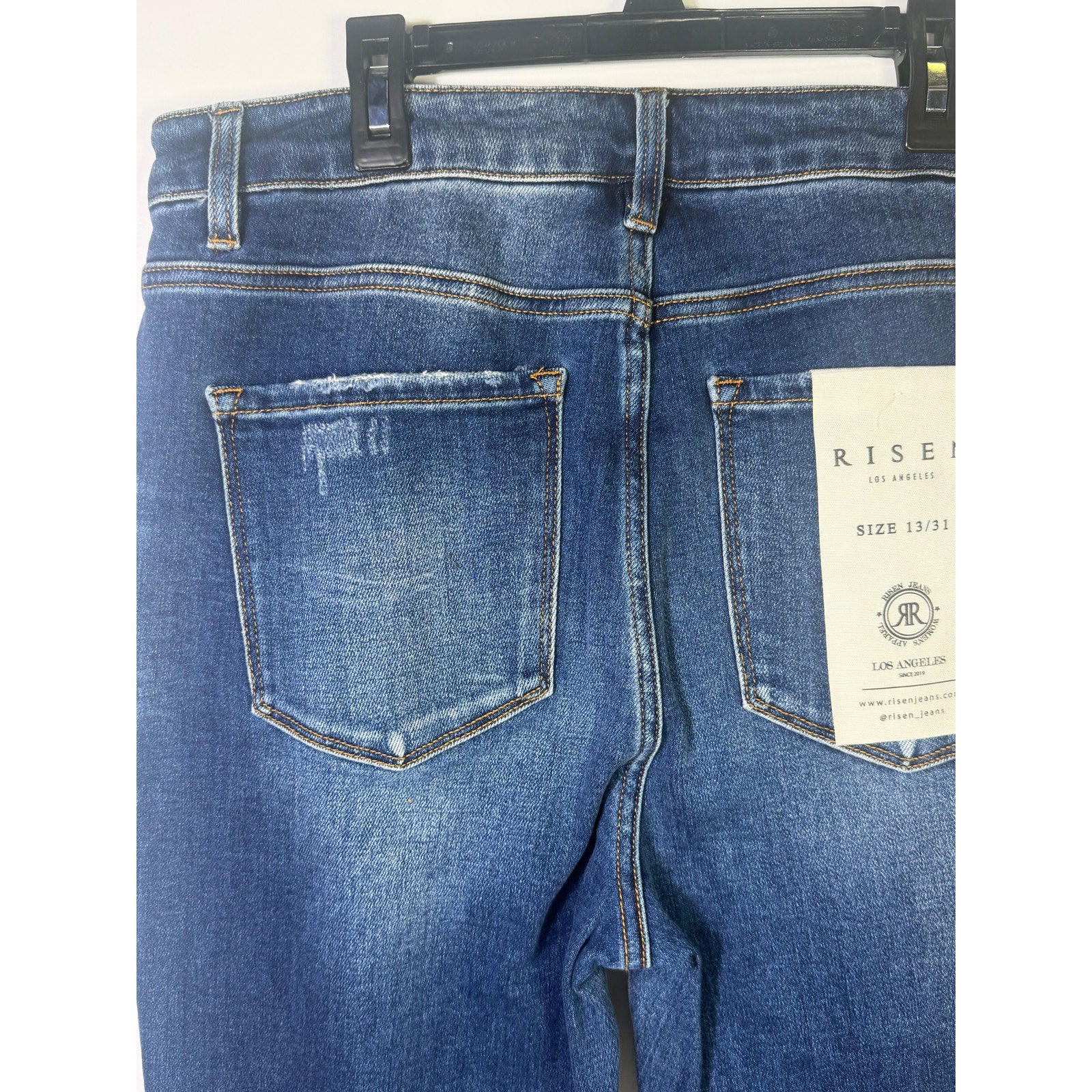 Risen Jeans women's size 13/31 dark wash distressed flare jeans, showing the fit and distressed details.