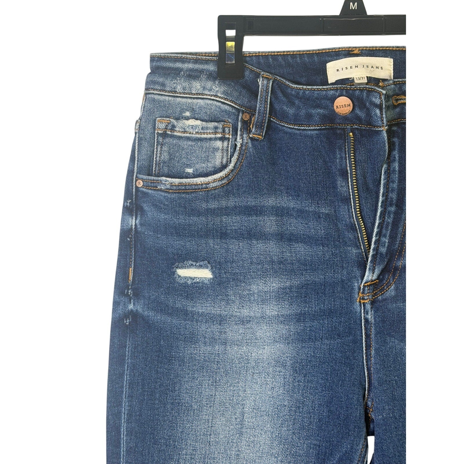Risen Jeans women’s size 13/31 dark wash distressed flare jeans, front view with ripped details and frayed hems.