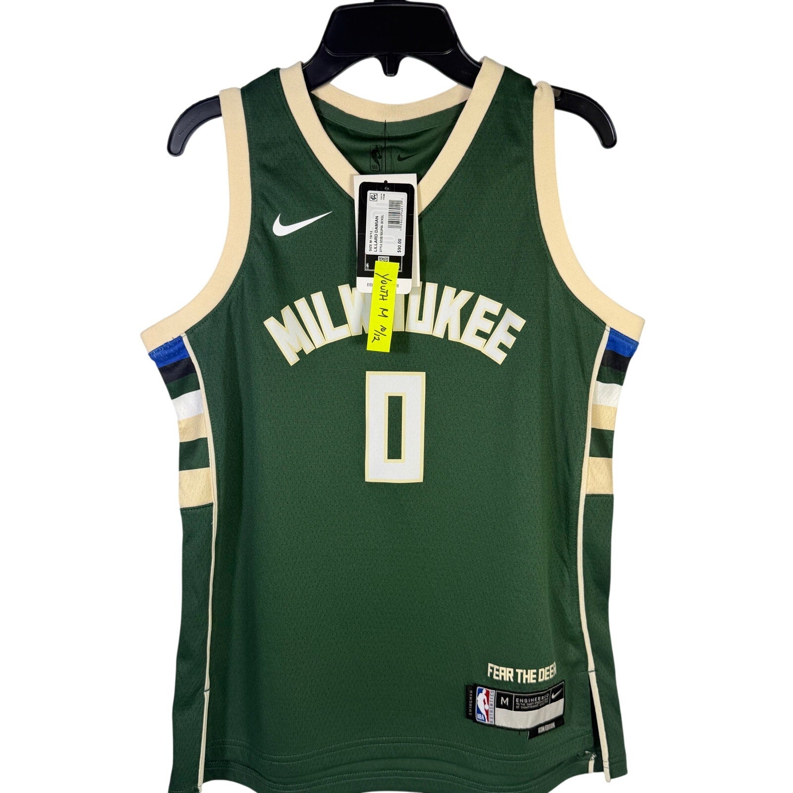 Nike Milwaukee Bucks Damian Lillard #0 youth swingman jersey in green, size M 10-12, displayed on a hanger.