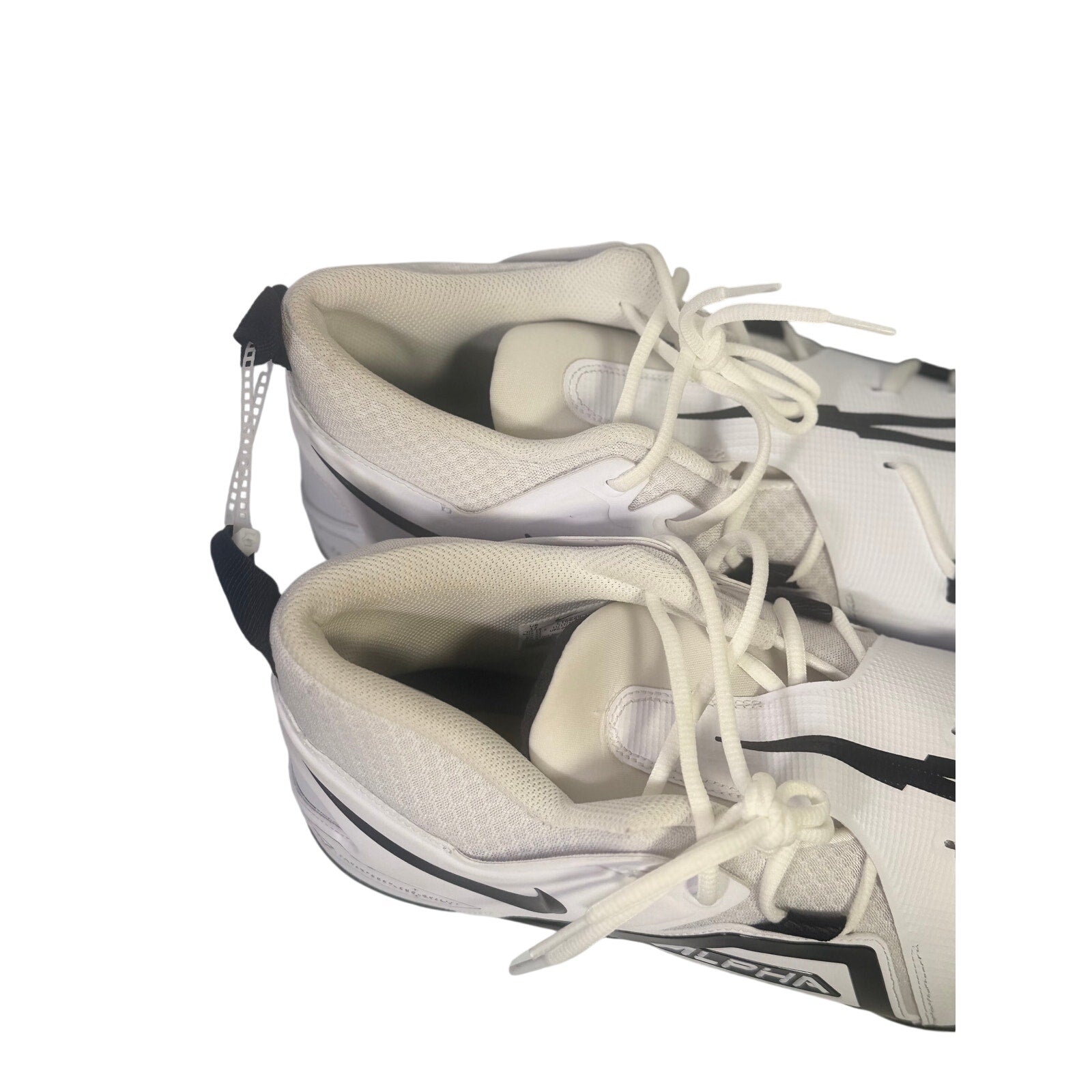 Nike Alpha men's football cleats in white and black, size 17, with studded soles and Nike branding on the sides.