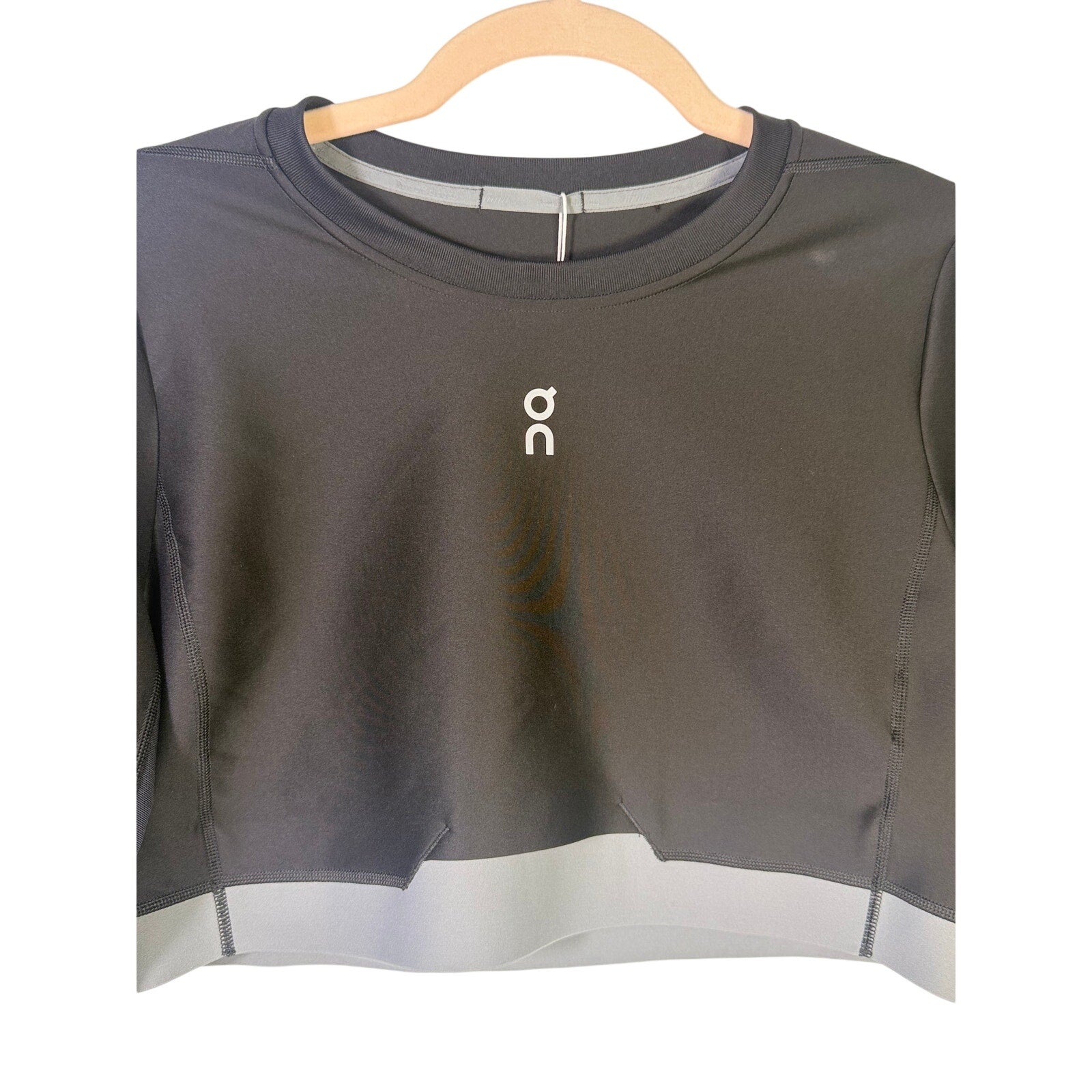 Black On Women’s Train long-sleeve crop athletic top in size XL, shown laid flat with visible logo and fitted design.