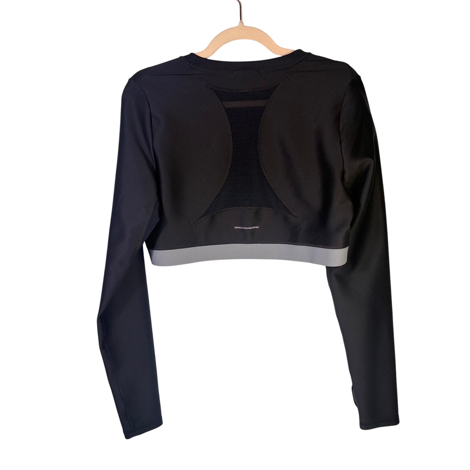 Black On women's Train long-sleeve crop athletic top in size XL, shown on a hanger with a fitted design and athletic fabric.