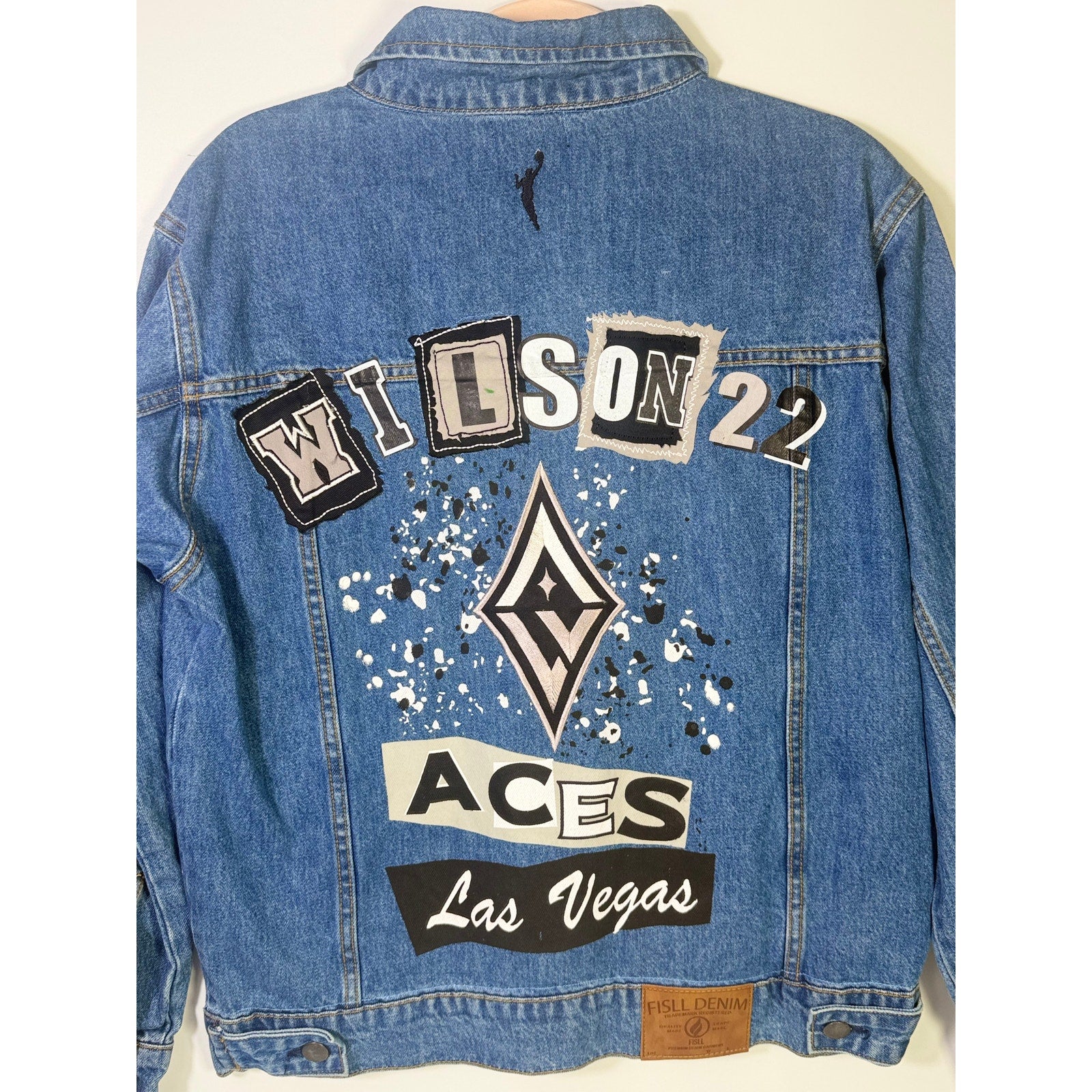 FISLL Las Vegas Aces Wilson #22 denim jacket, unisex medium size, new with tags, featuring team logo and classic denim design.