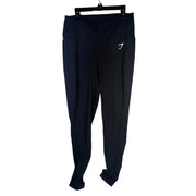 Black Gymshark women's high-waisted side pocket leggings laid flat, showing the sleek fit and pocket details.
