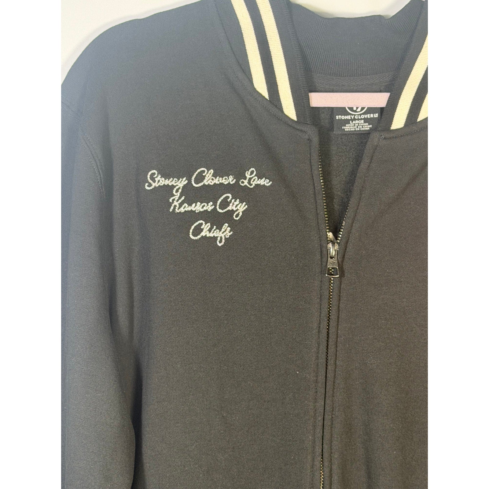 Stoney Clover Kansas City Chiefs women's varsity jacket in black, size large, featuring team logo and varsity style details.